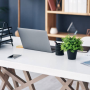 Shot of a laptop and other various items on a work desk in a modern office